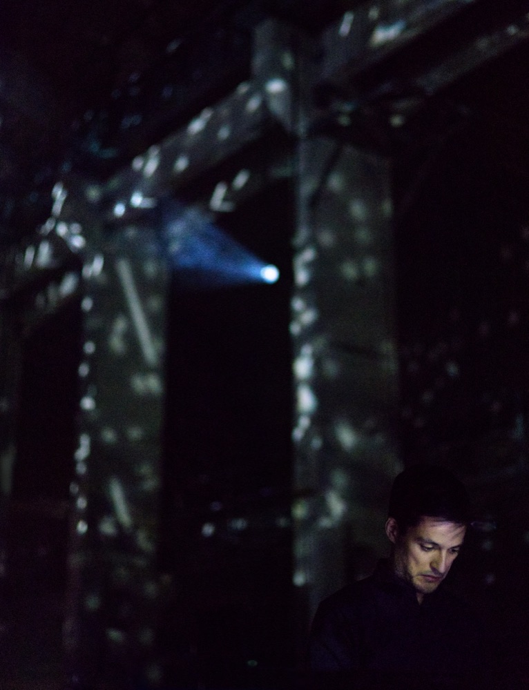 Sergio Luque on stage with projected textures