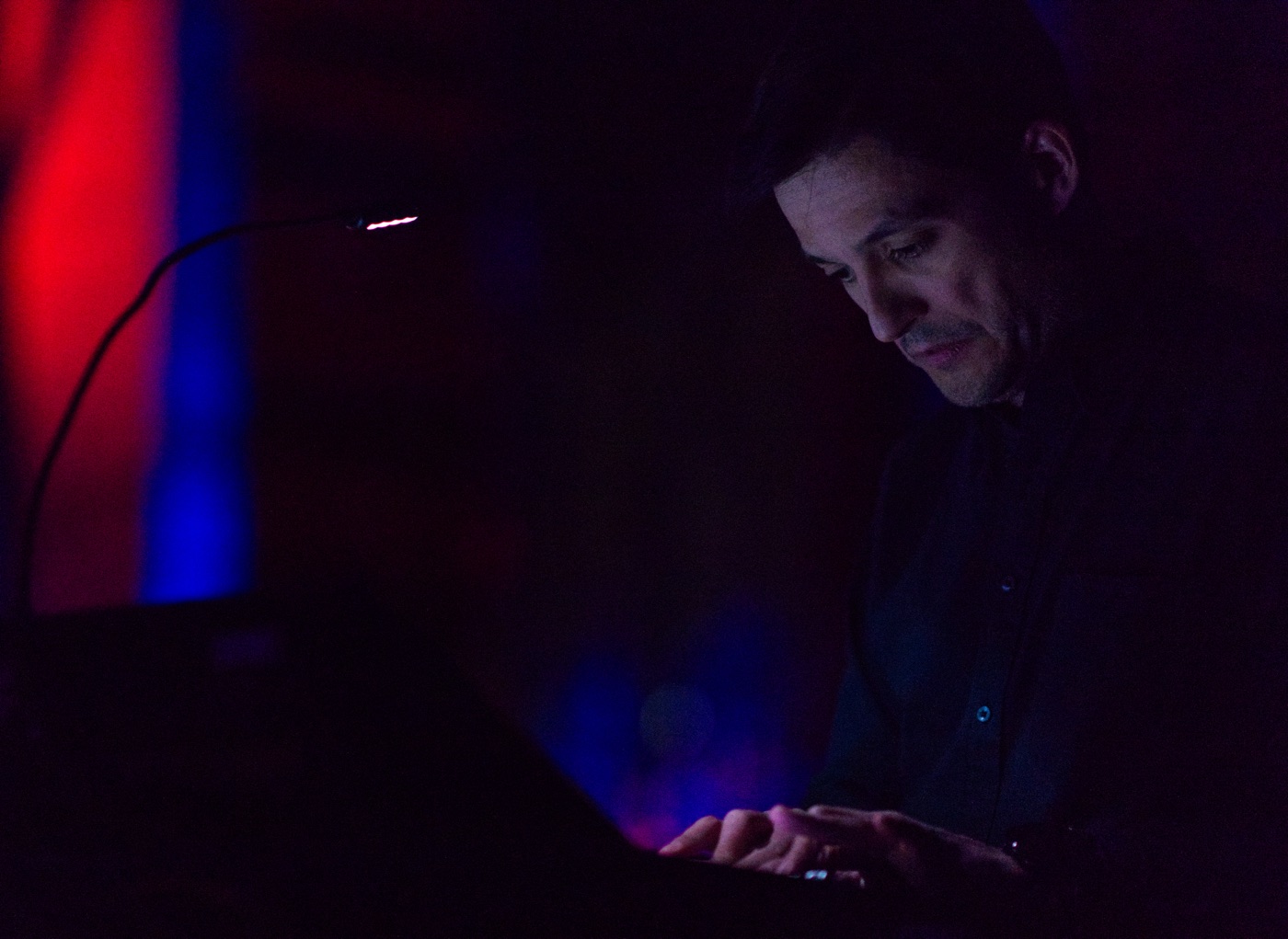 Sergio Luque at the keyboard, low stage light